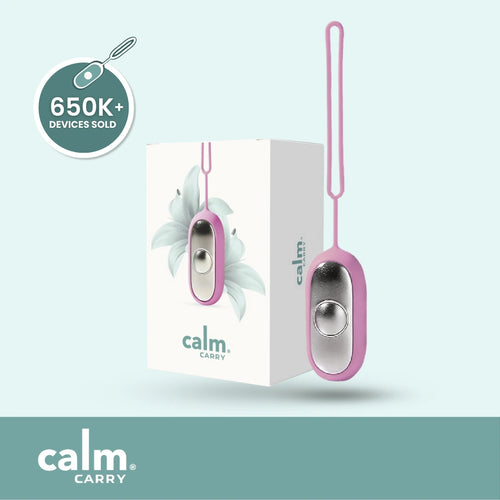 Pink CalmCarry device with packaging on a light blue background